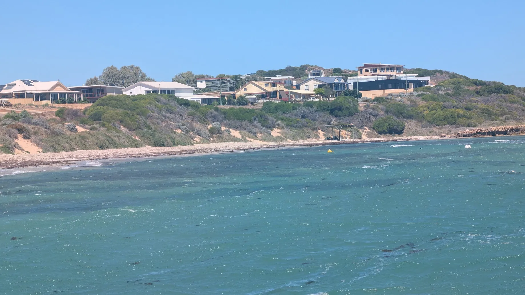 A photo of houses along a coastline.